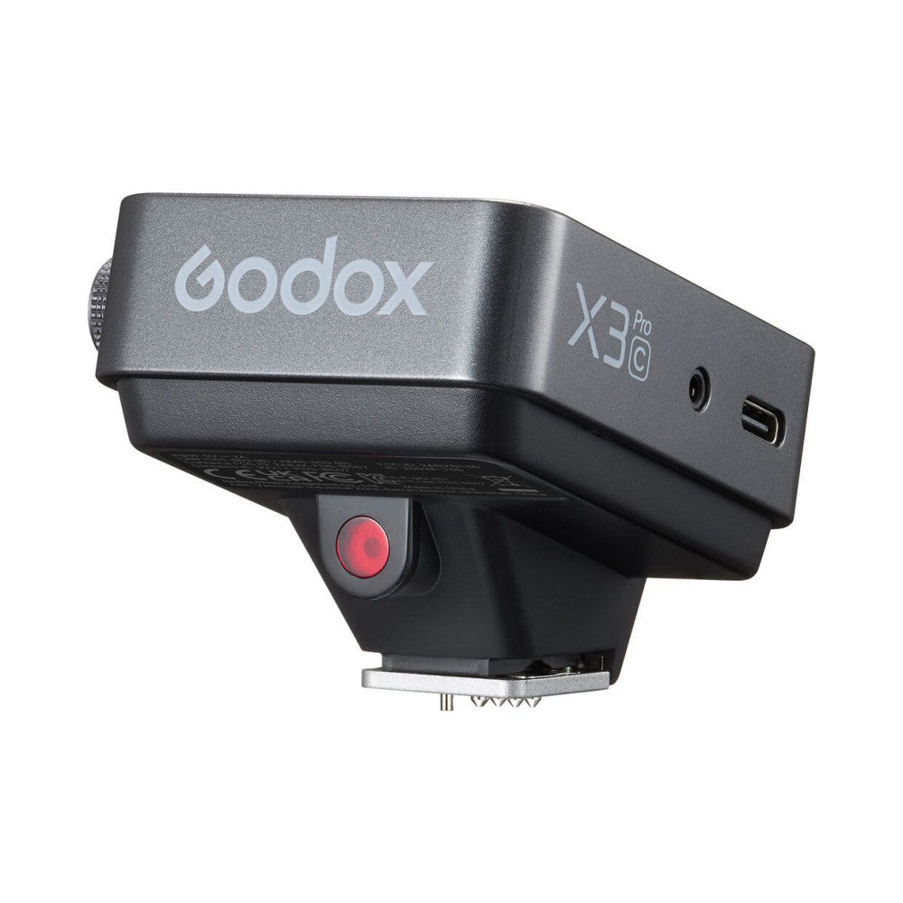 Side view of Godox X3 Pro Sony wireless flash trigger showing gray body, red sync button, USB-C port, and hot shoe mount.