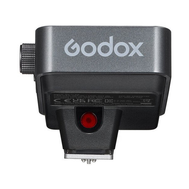 Top-down view of Godox X3 PRO wireless flash trigger showing gray body with logo, black bottom section, red indicator light, and hot shoe mount.