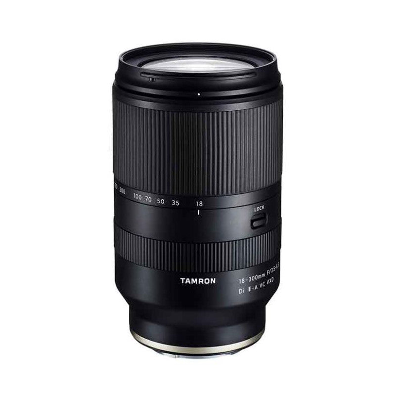 Black Tamron 18-300mm telephoto lens shown from front angle against white background, displaying barrel, focus ring, and focal length markings.