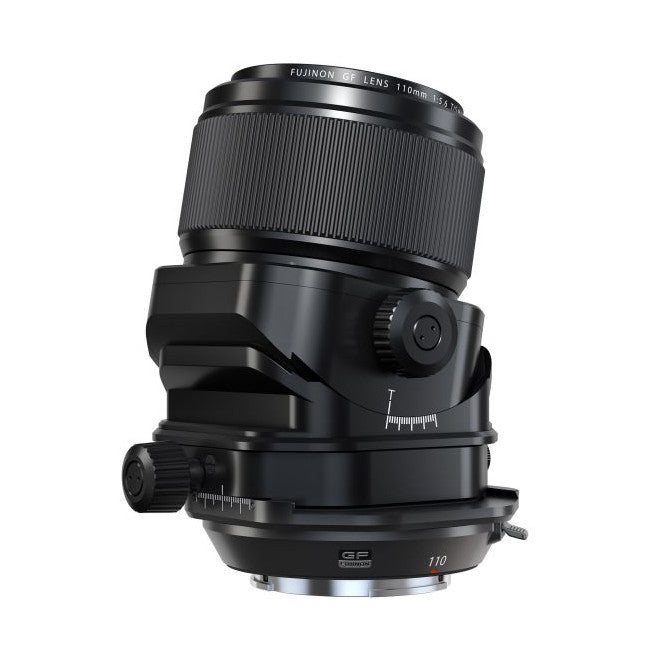 Black Fujifilm macro lens with tilt-shift mechanism shown from front three-quarter angle against white background