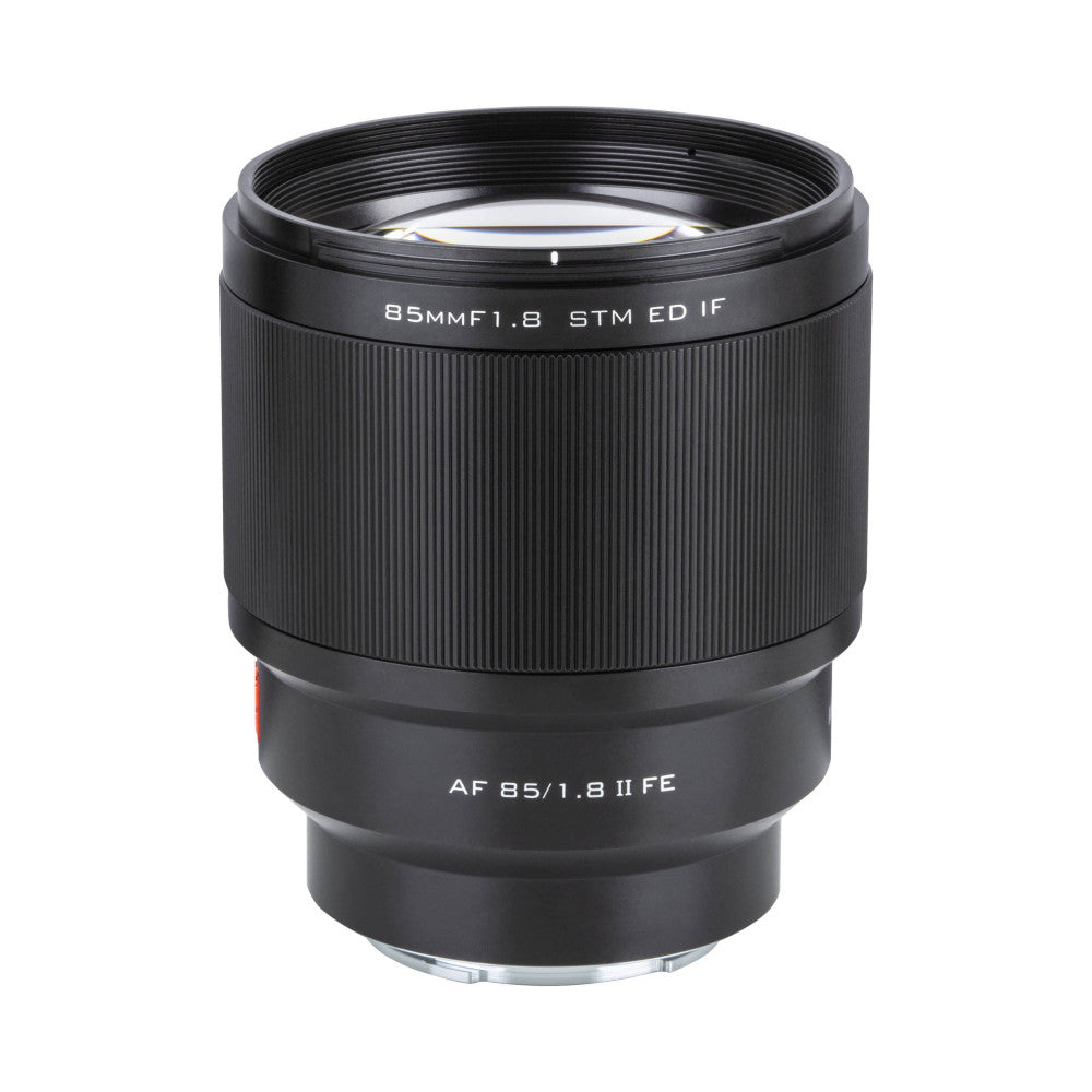 Black telephoto lens shown at three-quarter angle against white background, displaying front element, barrel with ribbed texture, and Sony E-mount base.