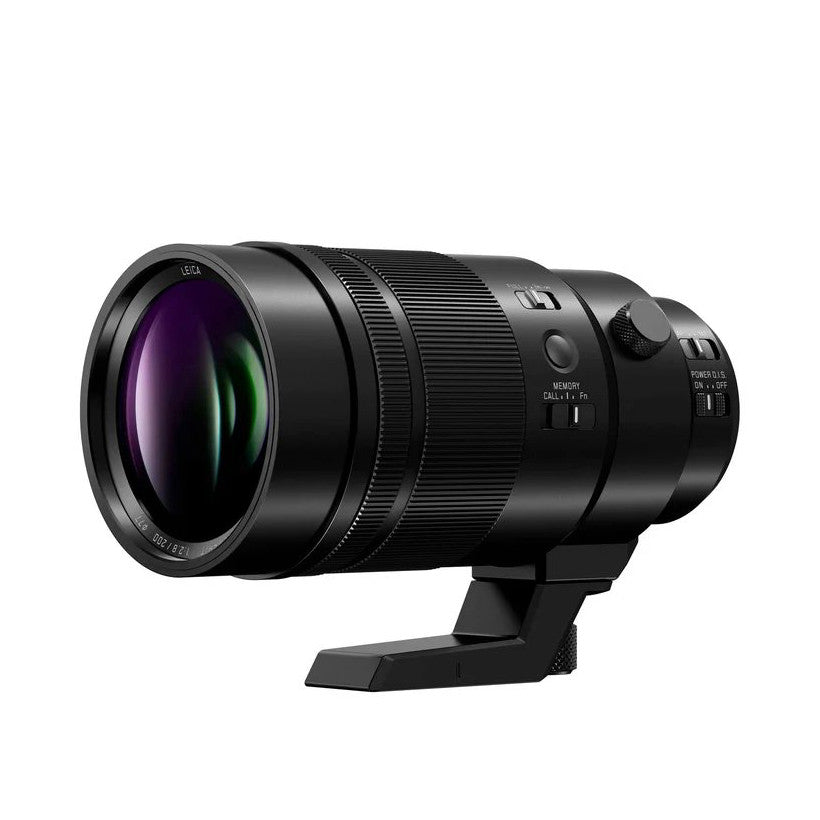 Black telephoto lens with purple-tinted glass element, shown from left side angle against white background with tripod collar visible.