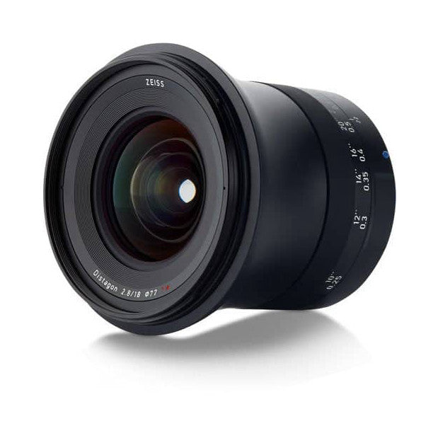 Black Zeiss Milvus 18mm f/2.8 lens shown from the side angle, displaying front glass element, focus ring, and distance markings on white background.
