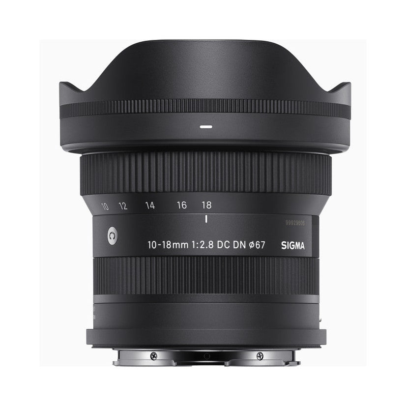 Front view of black Sigma 10-18mm f/2.8 DC DN lens with hood attached, showing focal length markings and specifications on barrel.