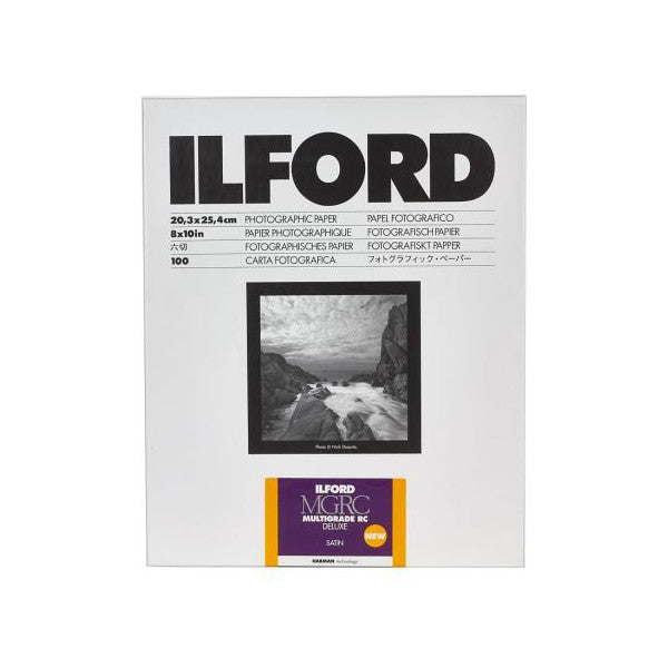 Front of Ilford Multigrade Deluxe Satin photographic paper packaging showing product specifications, sample black and white landscape photograph, and purple product label.