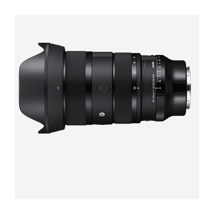 Side view of a black Sigma 28-45mm f/1.8 DG DN Art lens with hood attached, showing focus ring and depth scale markings.
