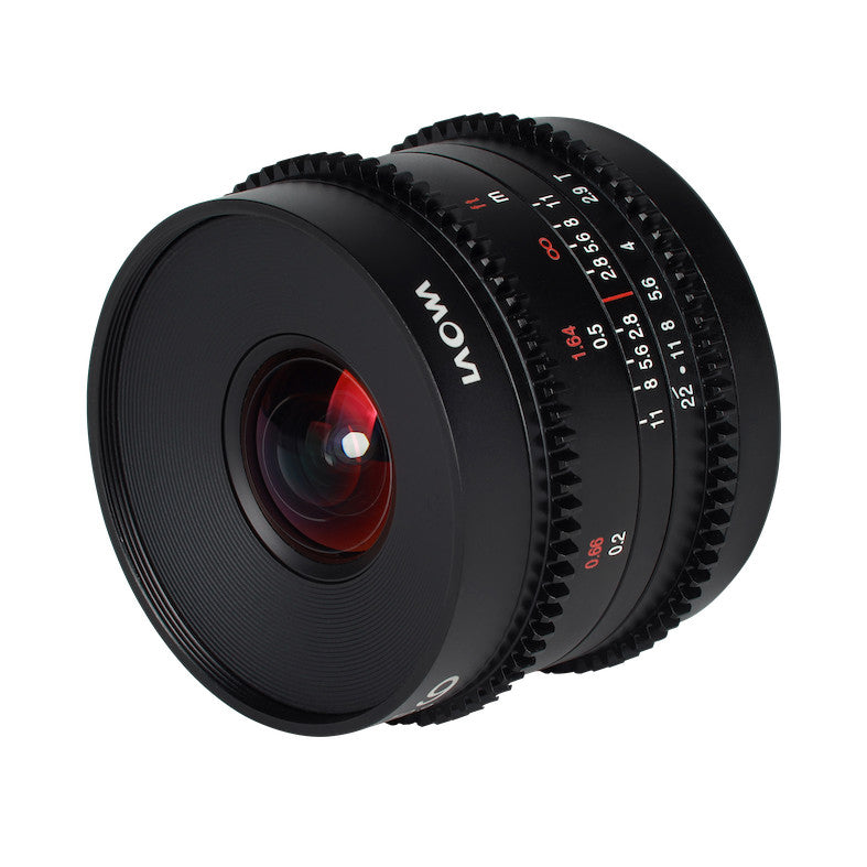 Black cinema lens shown at an angle, displaying focus ring, aperture markings, and red-tinted glass element visible through the front.