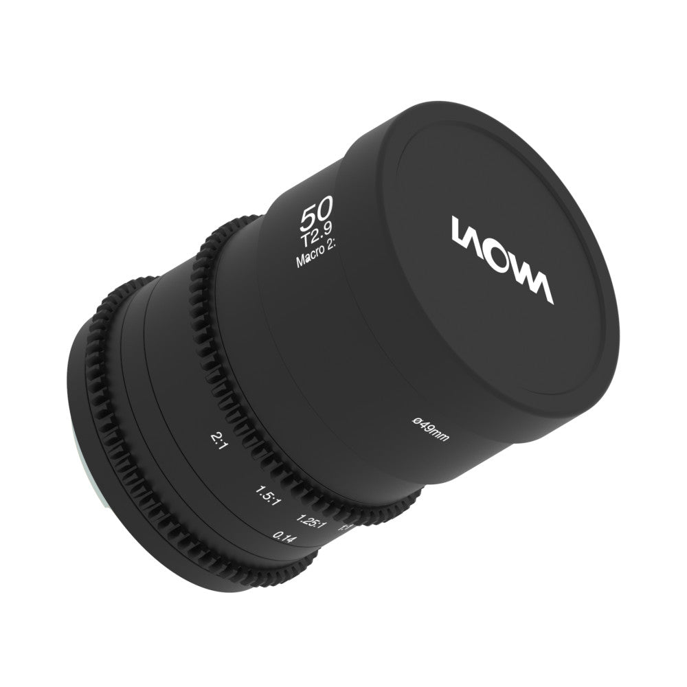 Black macro cinema lens angled view showing focus ring, aperture markings, and lens cap with brand name visible.