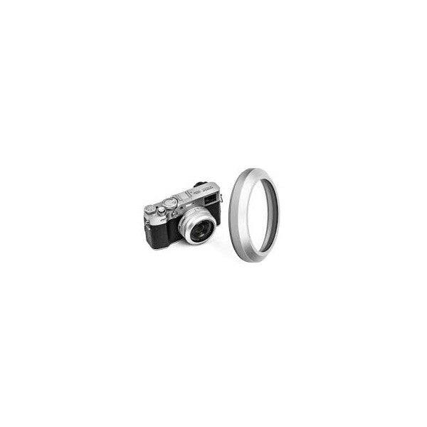 Silver UV filter ring displayed next to vintage rangefinder camera, showing filter's circular glass element and metal frame from front angle.