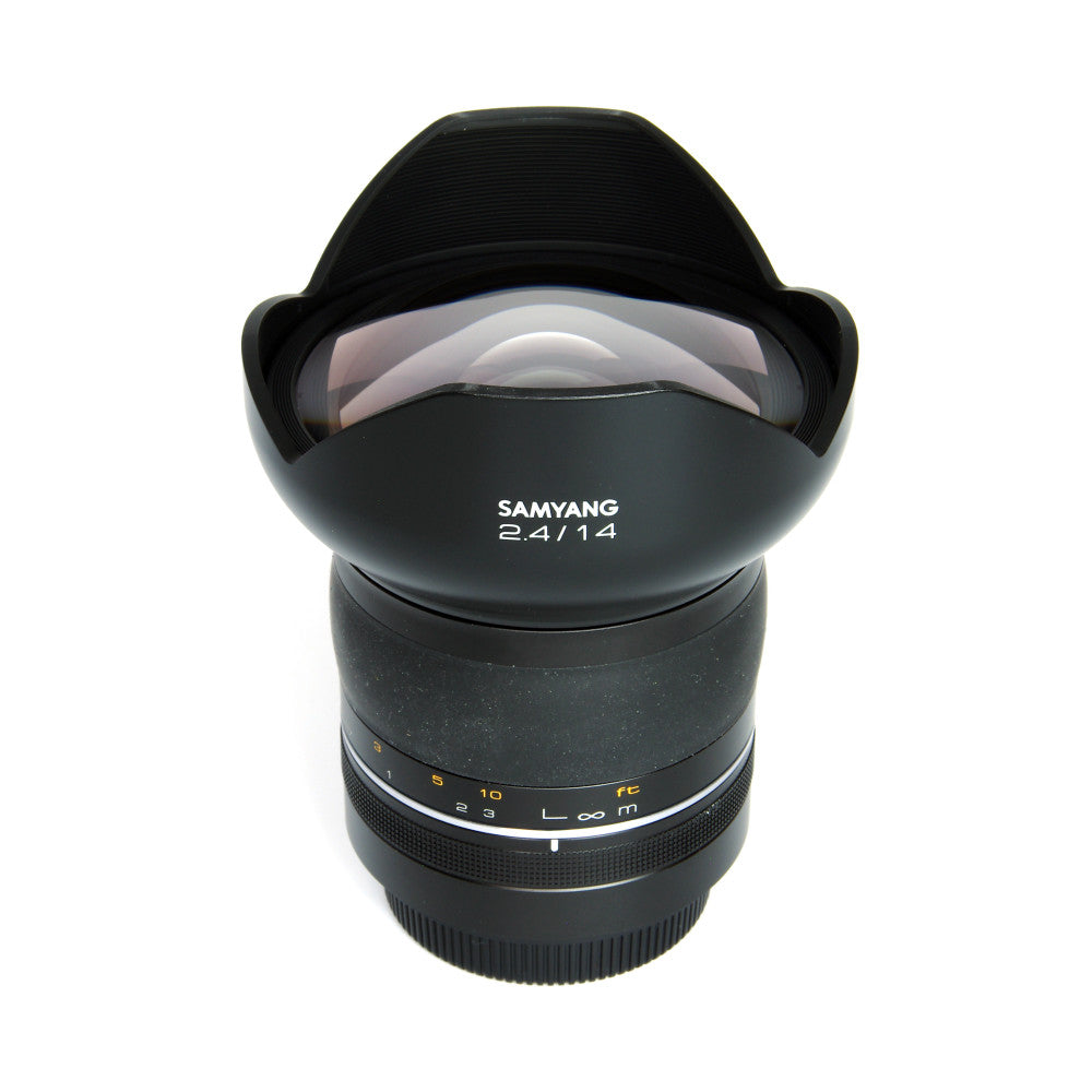 Front view of Samyang 14mm f/2.4 XP Premium lens showing barrel, focus ring, and lens hood against white background.