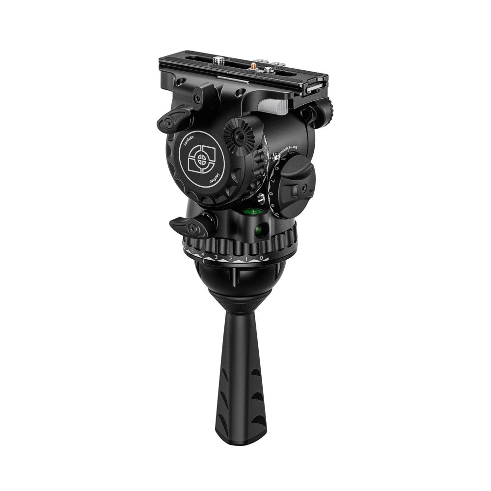 Black professional fluid video head mounted on tripod leg, shown in side angle view against white background.