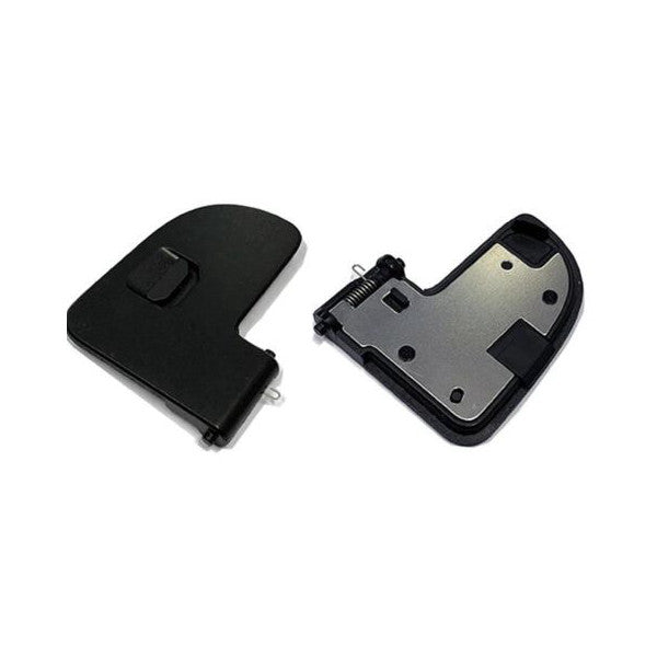 Two views of a black and gray battery door component, showing the exterior black cover on the left and the interior silver metal plate with mounting hardware on the right.