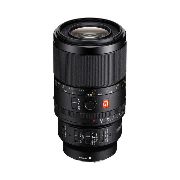 Black Sony macro lens photographed from the front at a slight angle, showing the barrel, focus ring, aperture scale, and control buttons against a white background.