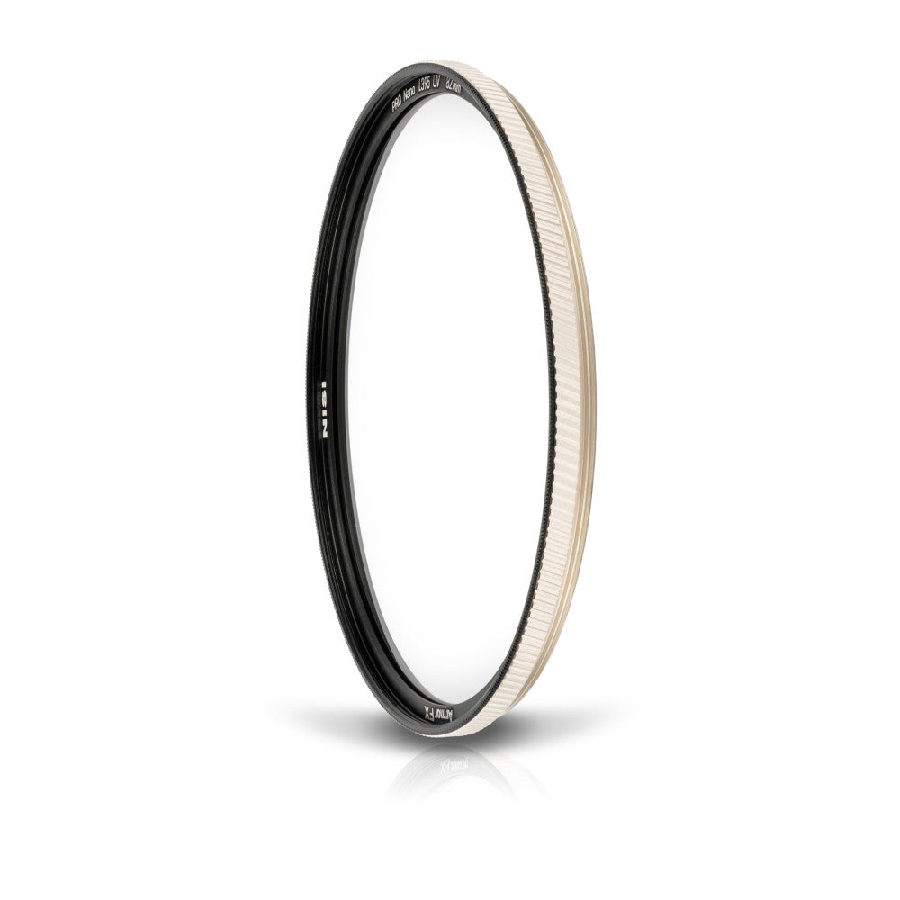 A circular UV filter with black and cream-colored rim shown at a slight angle against a white background, displaying the filter's protective glass element and metal housing.