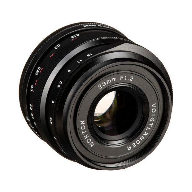 Black Voigtlander Nokton 23mm f/1.2 lens shown at an angled front view, displaying the glass elements and focus ring markings.