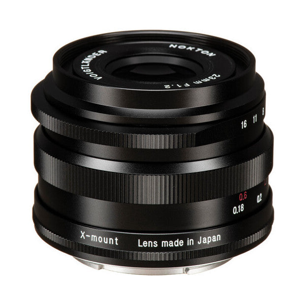 Black Voigtlander Nokton 23mm f/1.2 lens for Fujifilm X-mount shown from front angle, displaying glass elements and focus ring.