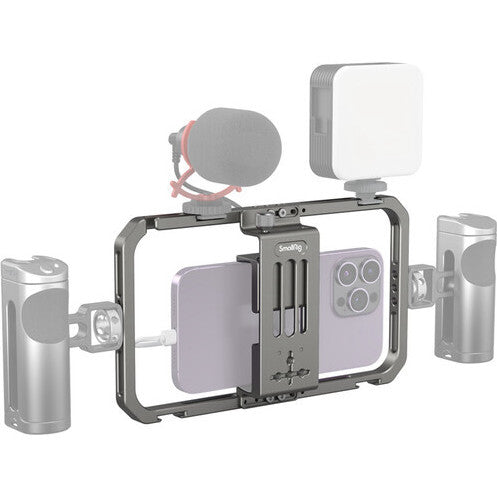 SmallRig mobile phone cage with mounted microphone, LED light, and side handles shown from front-angled view against white background.