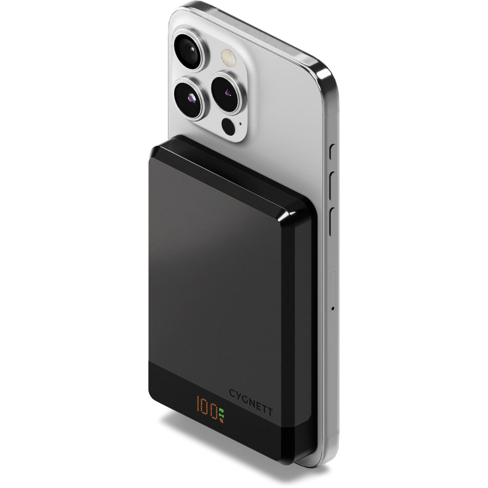 Silver iPhone 12 Pro with triple camera setup attached to black Cygnett magnetic wireless power bank showing 100% battery indicator.