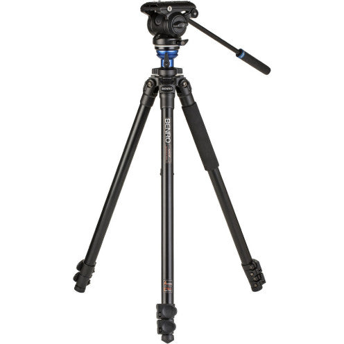 Professional video tripod with fluid head shown from front angle against white background, displaying extended legs and articulated pan handle.