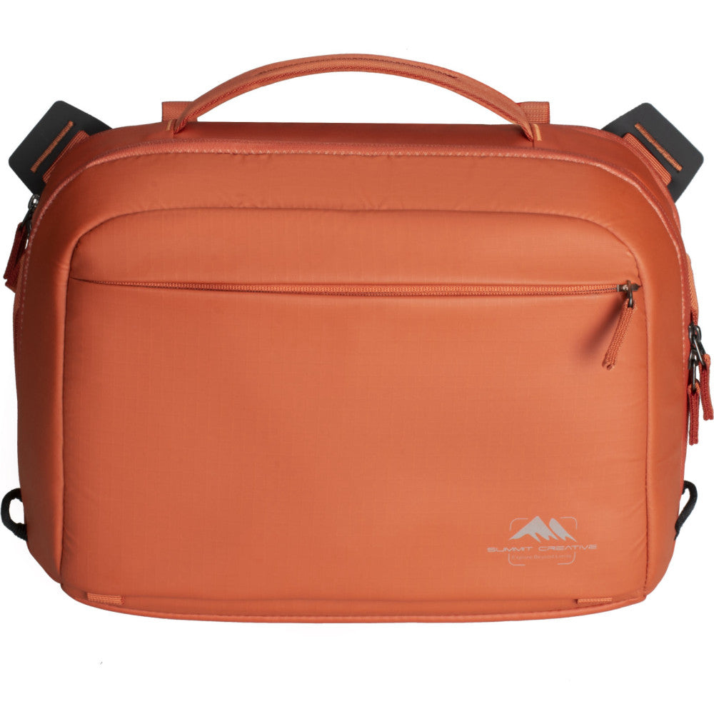 Orange Summit Creative Tenzing shoulder bag shown from front view with top handle, front zipper pocket, and side straps visible against white background.