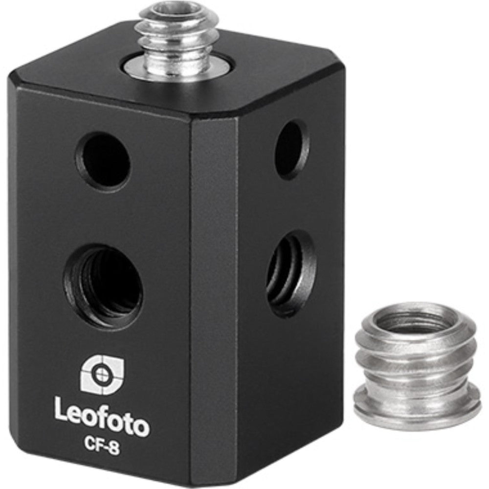 Black cubic mounting adapter with multiple threaded holes and silver screw on top, shown with detached metal adapter piece beside it.