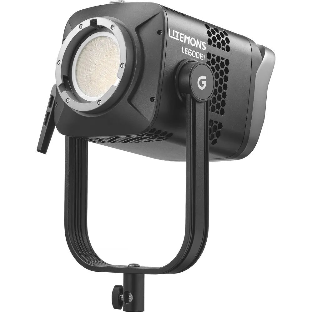 Black LED studio light mounted on stand, showing front lens and control dial, angled three-quarter view against white background.