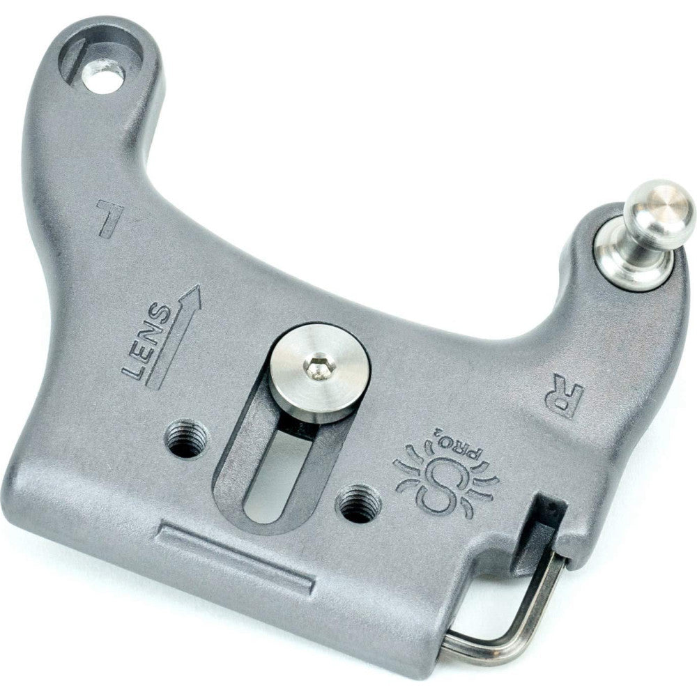 Gray metal camera mounting plate with adjustment slots, dual ball sockets, and threaded holes, shown from above at an angle.