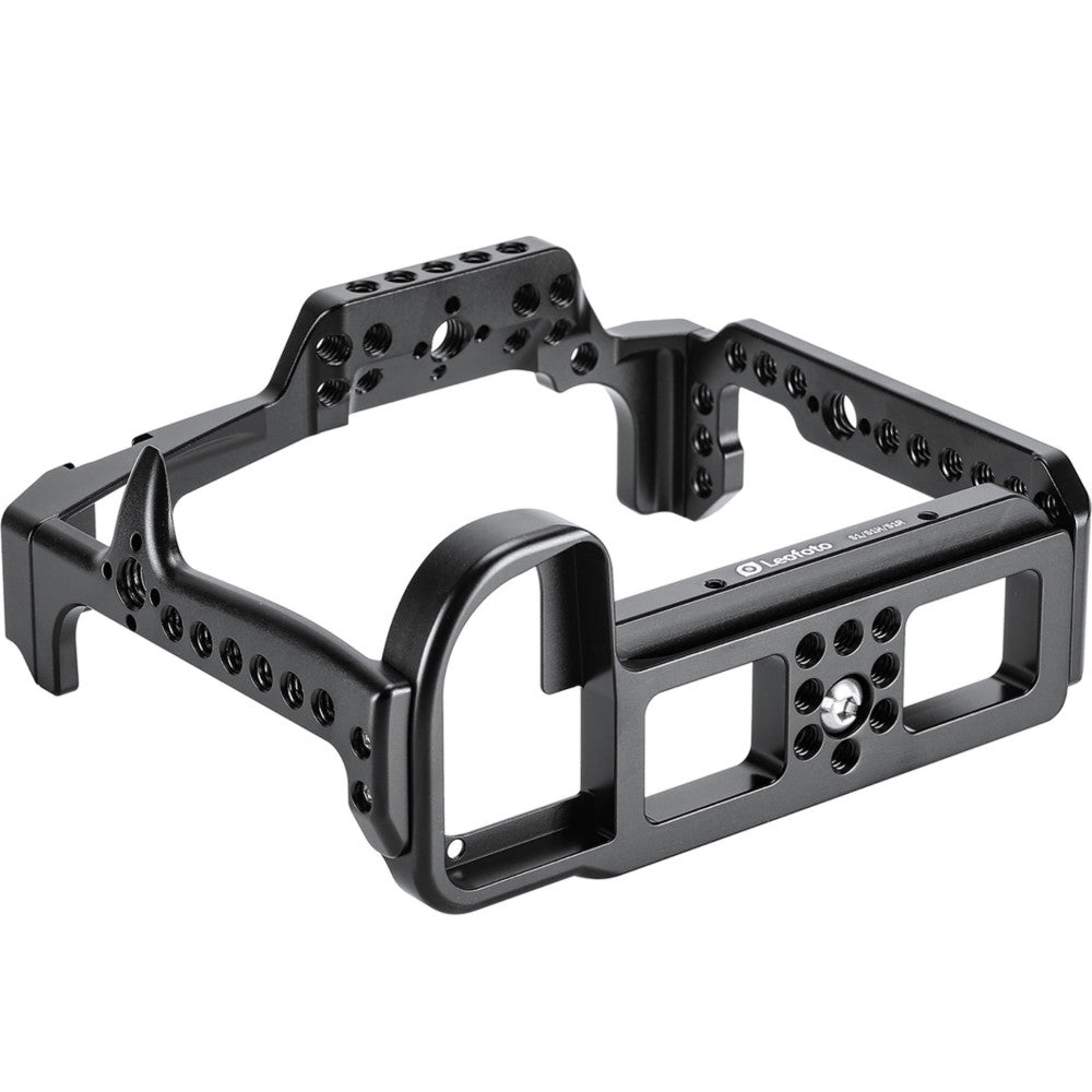 Black aluminum camera cage with multiple mounting points and handles, shown from a three-quarter angle against a white background.