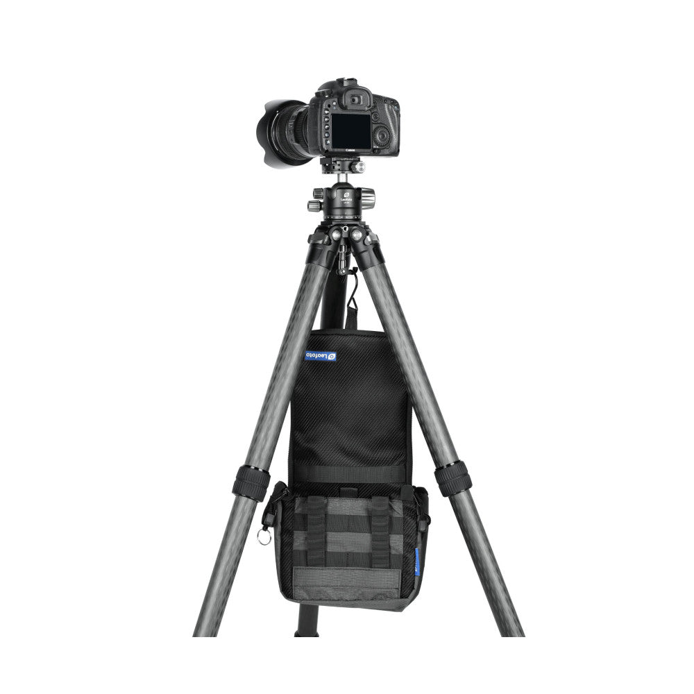 Canon camera on tripod with weight hook bag suspended beneath, demonstrating in-use setup on white background.