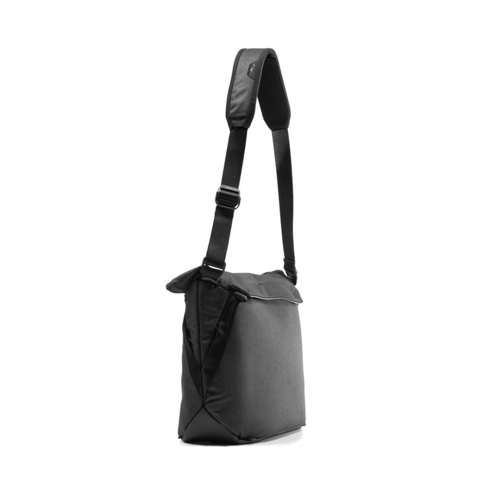 Black Peak Design Everyday Tote V2 shown from the side angle, displaying the shoulder strap and cylindrical bag structure against a white background.