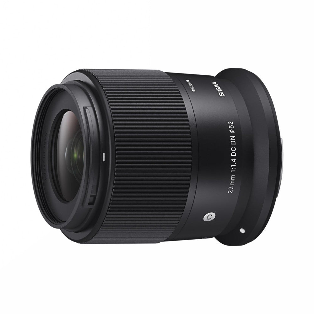 Black Sigma 23mm f/1.4 DC DN lens shown at three-quarter angle against white background, displaying front element and barrel with text specifications visible.