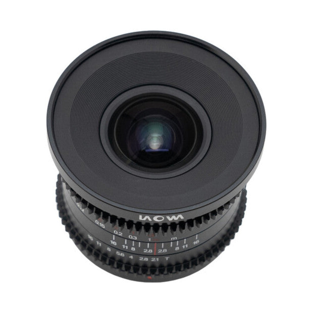 Front view of Laowa 6mm T2.1 cine lens showing glass element, focus ring with distance markings, and black metal barrel against white background.