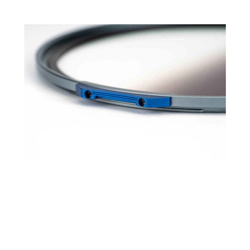 Close-up side view of a curved magnetic filter ring showing blue graduated coating and metal mounting points on white background.