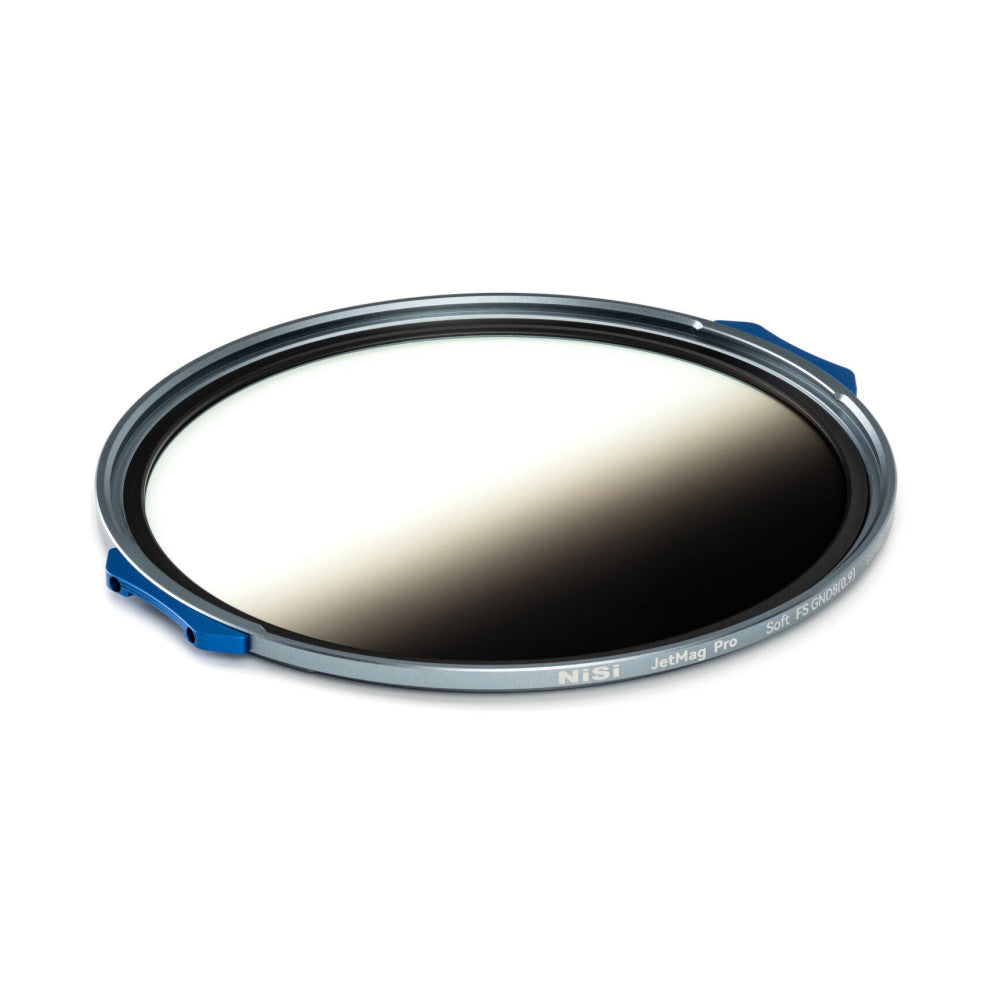 Angled top-down view of a circular magnetic filter with gray ring, blue lever clasp, and gradient gray-to-clear glass element showing light-to-dark transition.