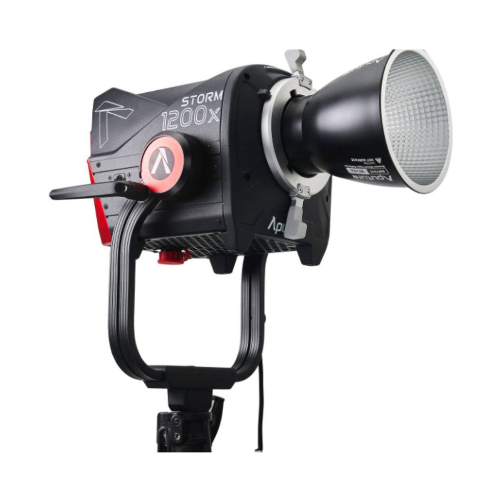 Side view of Aputure Storm 1200X LED light showing reflector, control dial with red accent, and mounting bracket against white background.