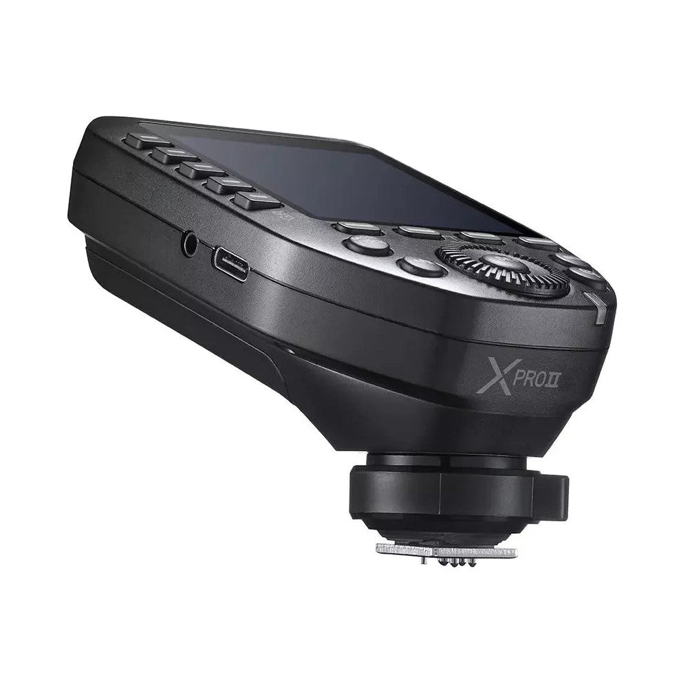 Black Godox XPro wireless flash trigger shown from side angle, displaying control buttons and USB port, mounted on shoe base.