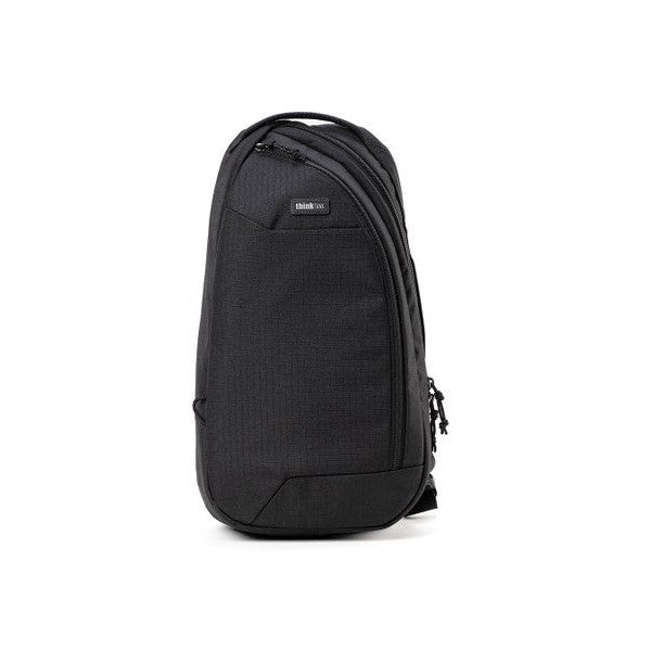 Black sling bag photographed from the front against a white background, showing the textured fabric exterior and single shoulder strap.