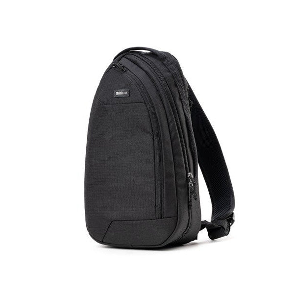 Black sling bag photographed against white background, showing front three-quarter view with single shoulder strap and multiple zippered compartments visible.