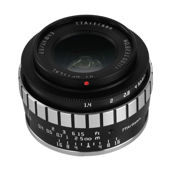 Top-down view of a black manual focus lens showing aperture ring, focus distance scale, and depth of field markings on the barrel.
