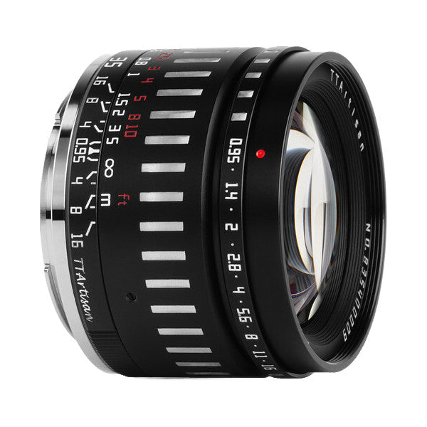 Close-up side view of a black TTArtisan 35mm f/0.95 lens showing focus ring markings and aperture scale against white background.