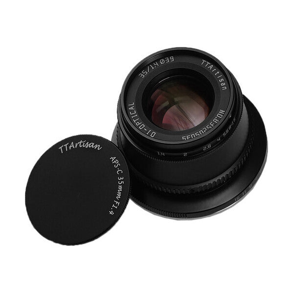 Black TTArtisan 35mm f/1.4 lens for Nikon Z mount displayed at an angle with its rear lens cap removed, showing glass elements inside.