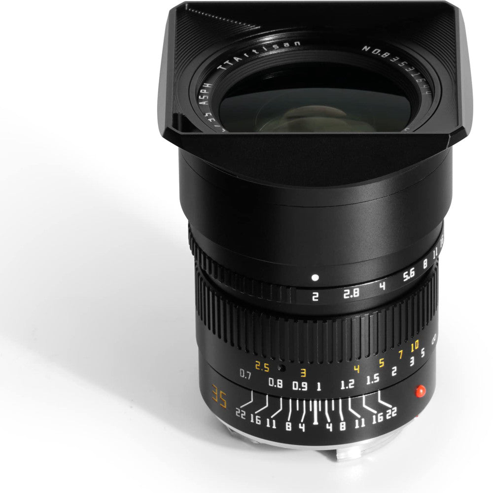 Black TTArtisan 35mm f/2 APO lens with rectangular hood, shown from front-angled view displaying focus ring and aperture scale markings.