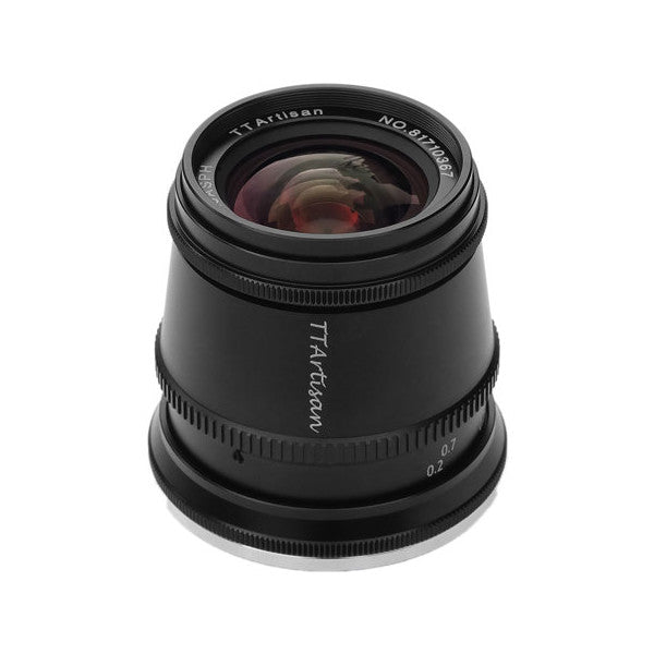 Black TTArtisan 17mm f/1.4 lens shown from front angle, displaying glass elements and focus ring against white background.