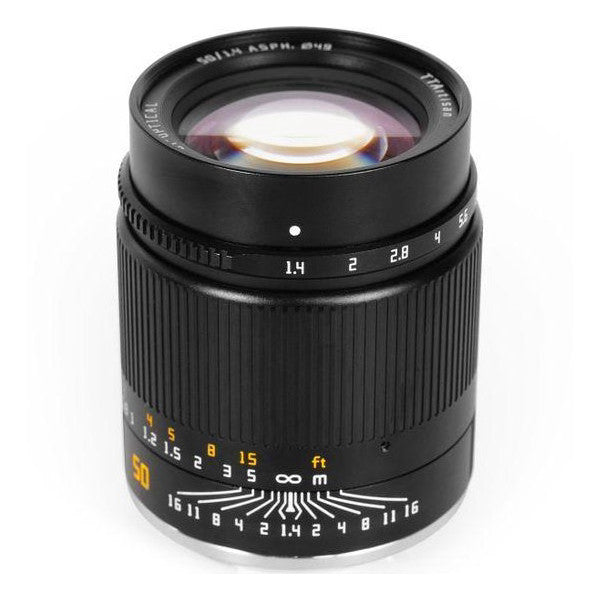 Black manual focus lens with aperture ring and focus scale, shown from front-left angle against white background.