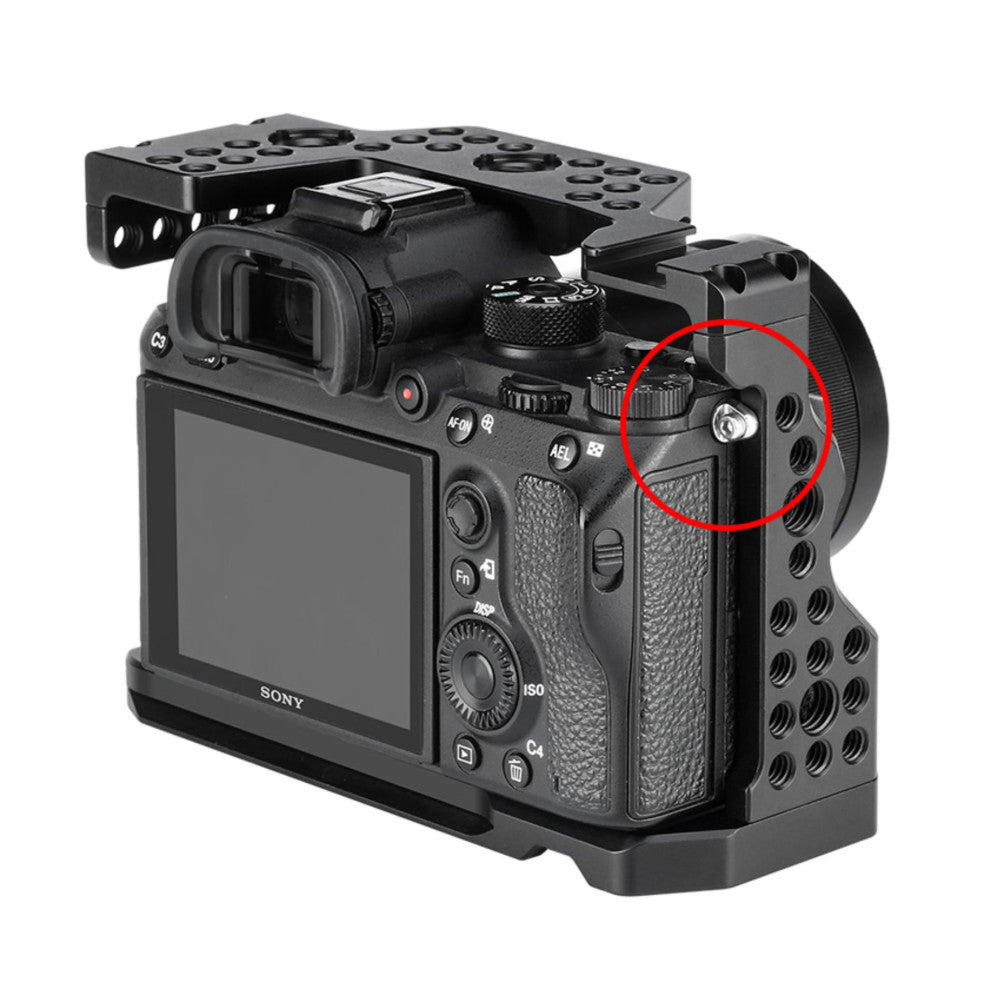 Black camera cage with mounting bracket attached to Sony mirrorless camera body, shown from rear three-quarter angle with red circle highlighting accessory mount point.