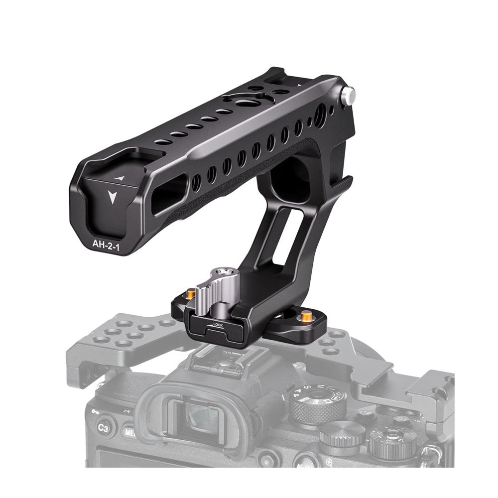 Black camera top handle mount with perforated rail design shown at an angle above a faded camera body, displaying the handle's grip structure and quick-release base plate.