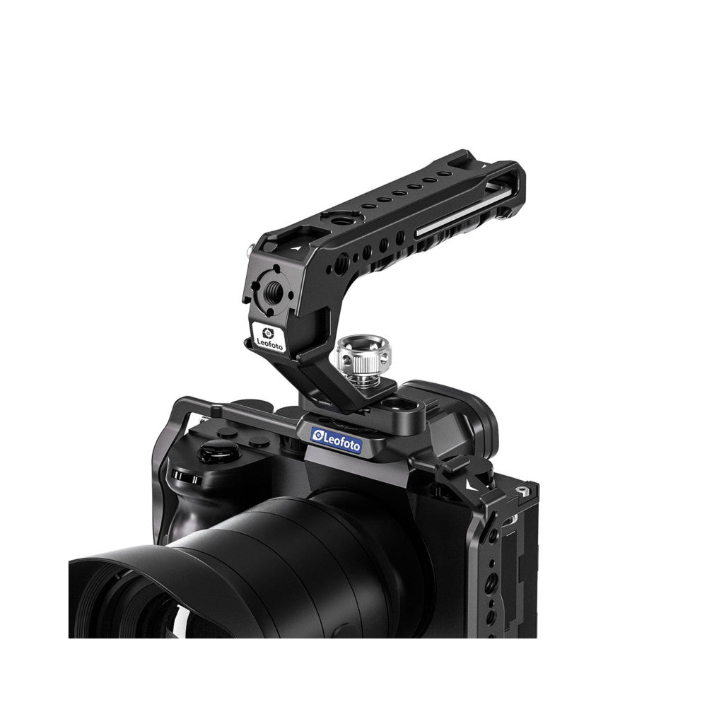 Black camera top handle with cold shoe mount attached to camera cage, shown in angled perspective view against white background.