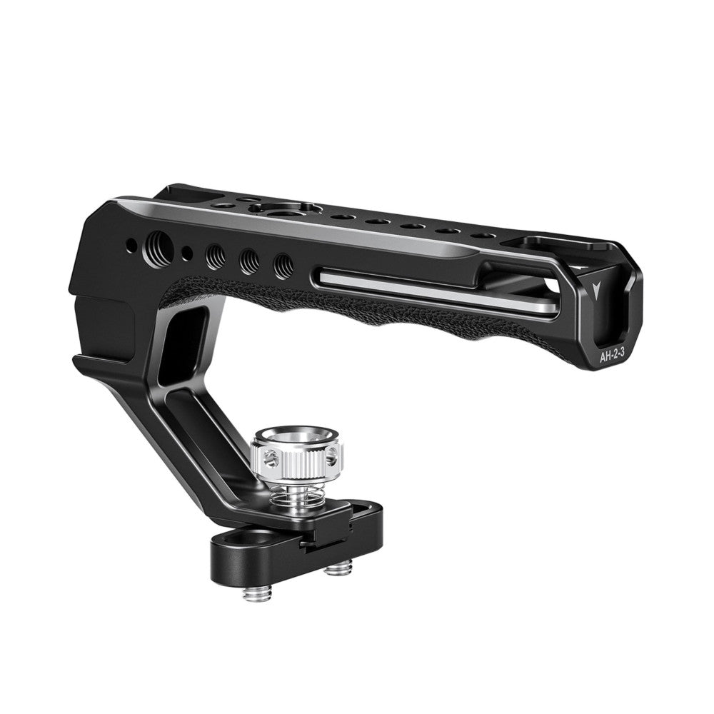 Black camera top handle with textured grip and integrated cold shoe mount, shown at three-quarter angle with detached aluminum shoe adapter.