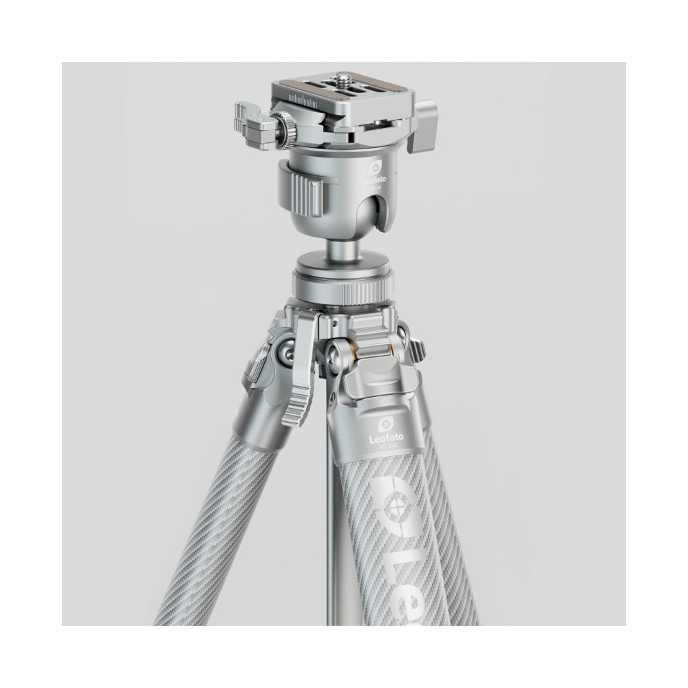 Silver carbon fiber tripod with ball head mounted on top, shown against white background in three-quarter view displaying legs and head assembly.