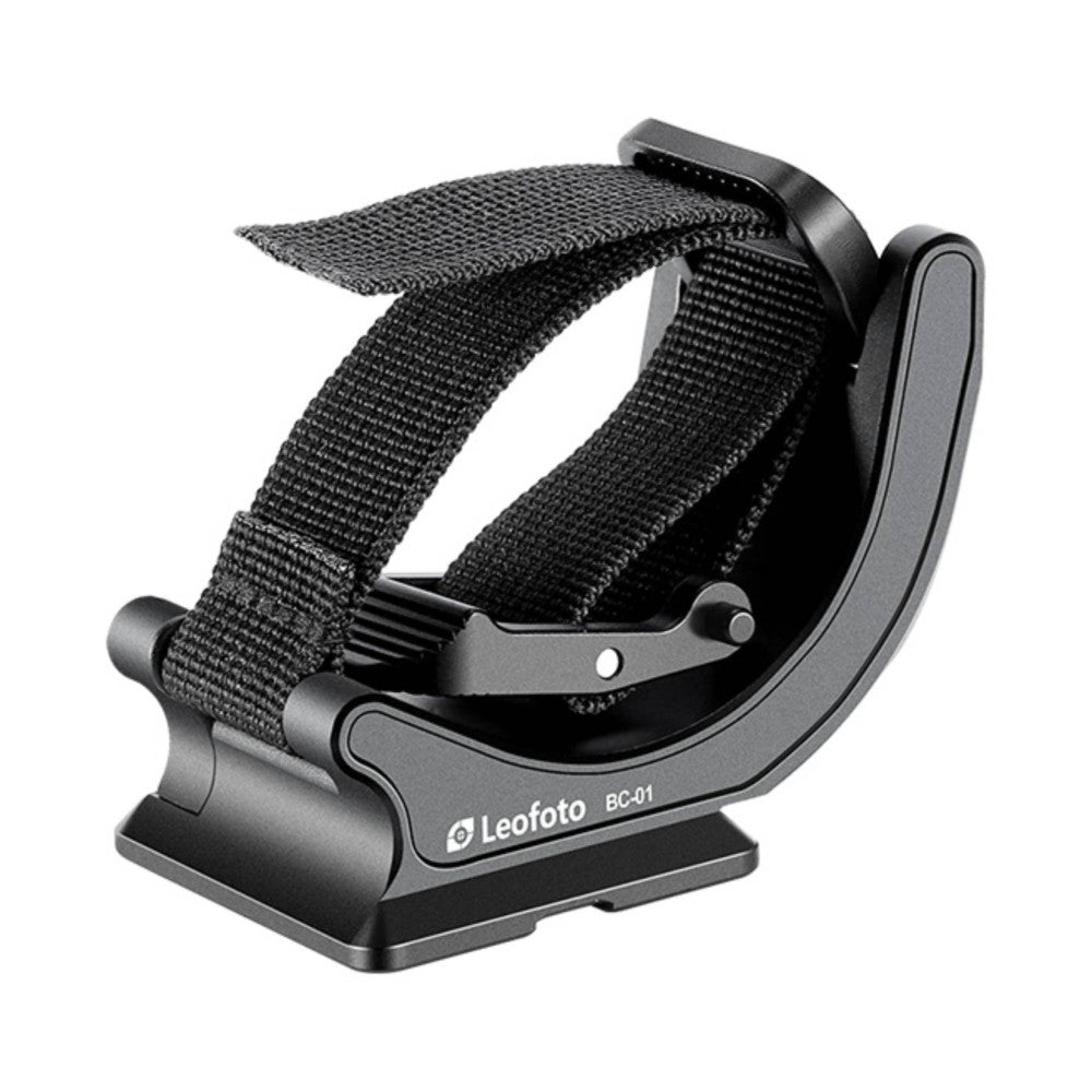 Black binocular clamp with nylon strap shown at three-quarter angle, displaying Arca Swiss mounting base and adjustment mechanisms.
